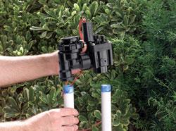 Escondido sprinkler repair team member installs backf