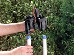 Escondido sprinkler repair team member installs backf