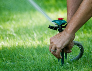 a tech is adjusting a sprinkler